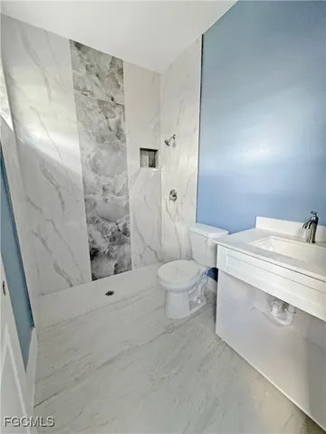 a bathroom with a toilet sink and shower