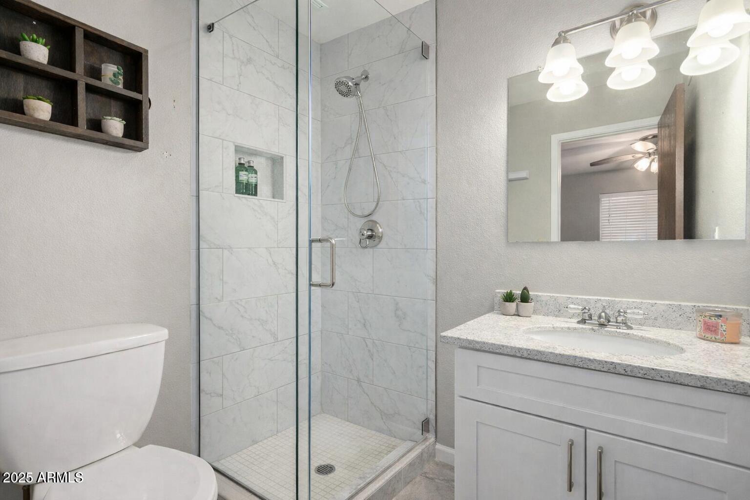 15601 North 27th Street, Unit 33 Phoenix, AZ 85032 - Photo 16 of 23 a bathroom with a sink a toilet and shower