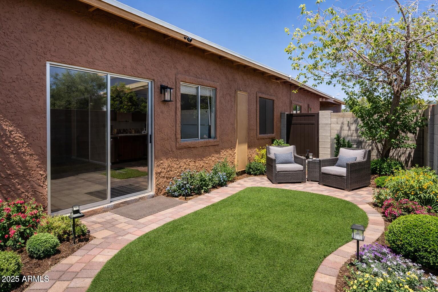 15601 North 27th Street, Unit 33 Phoenix, AZ 85032 - Photo 21 of 23 a view of a house with backyard tub and garden