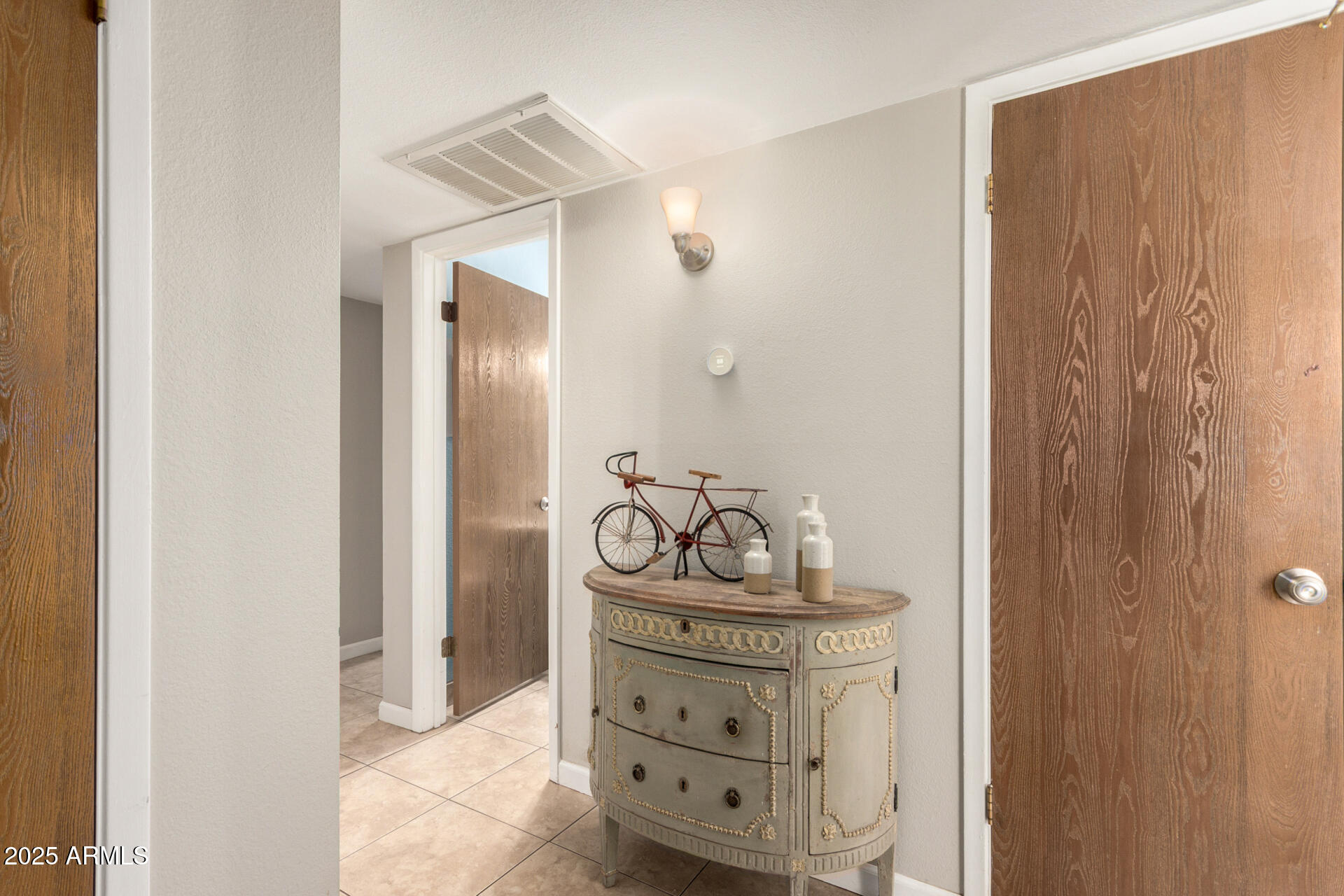 15601 North 27th Street, Unit 33 Phoenix, AZ 85032 - Photo 5 of 23 a bathroom with a light fixture a mirror and a sink