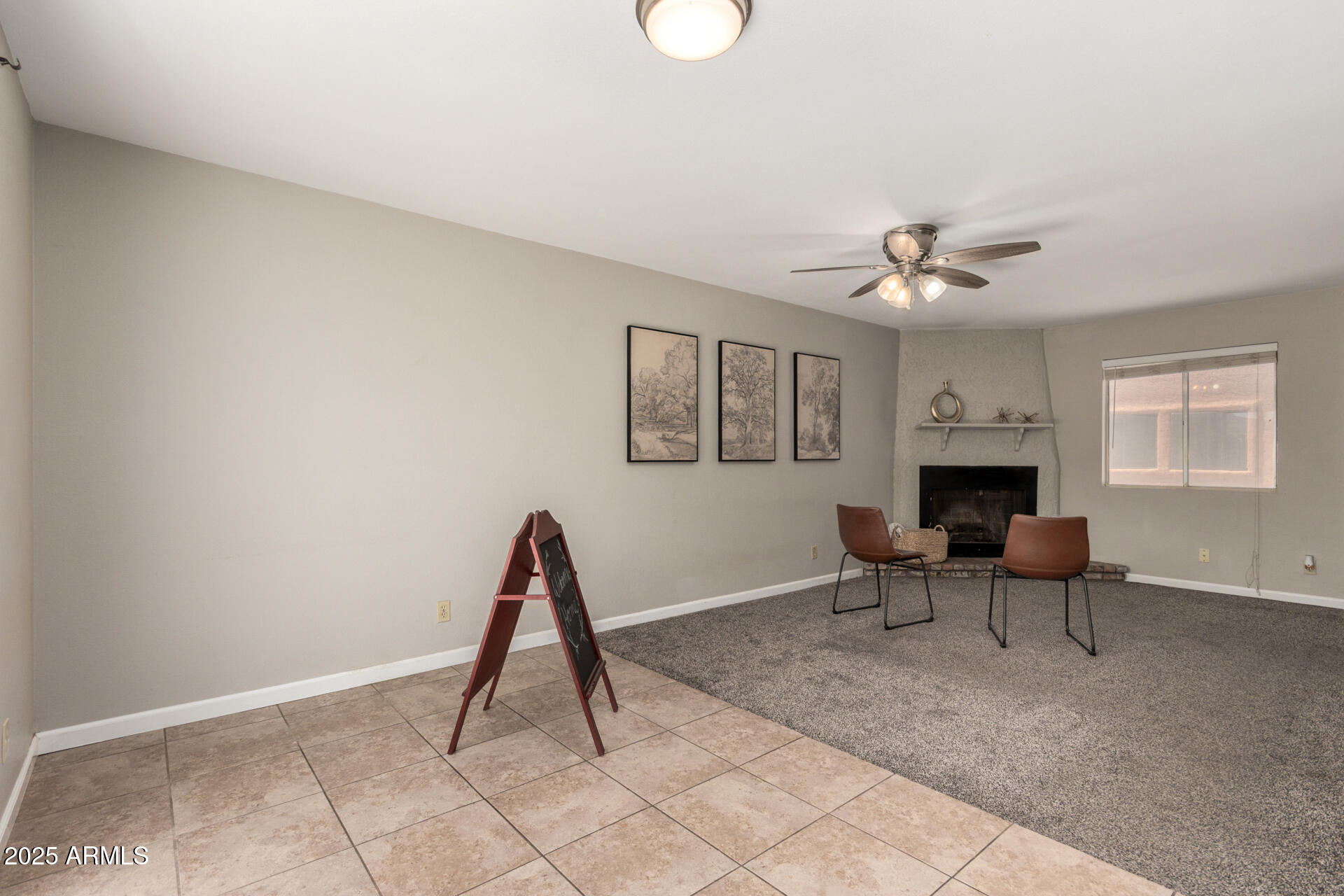 15601 North 27th Street, Unit 33 Phoenix, AZ 85032 - Photo 9 of 23 a living room with furniture a fireplace and a window
