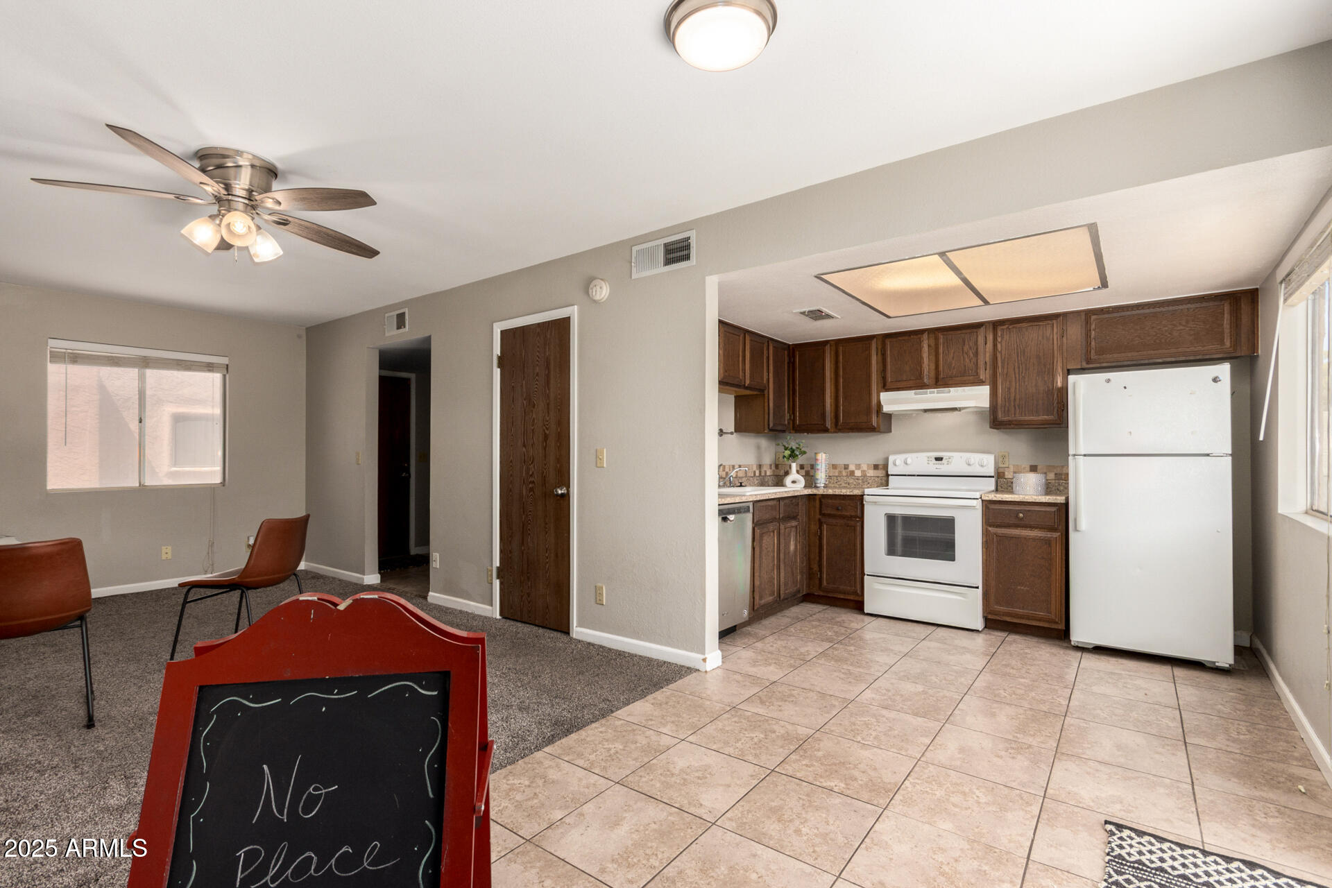 15601 North 27th Street, Unit 33 Phoenix, AZ 85032 - Photo 10 of 23 a large white kitchen with a stove a refrigerator and a sink