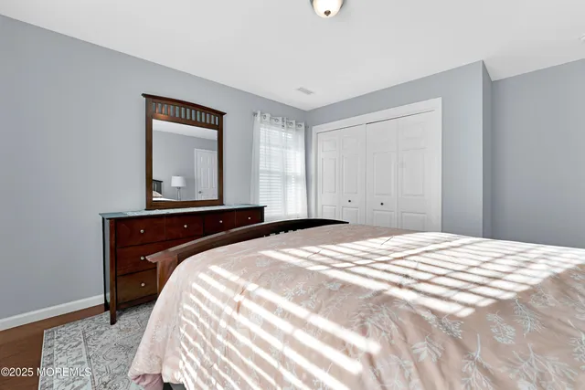 a bedroom with a bed couch and window