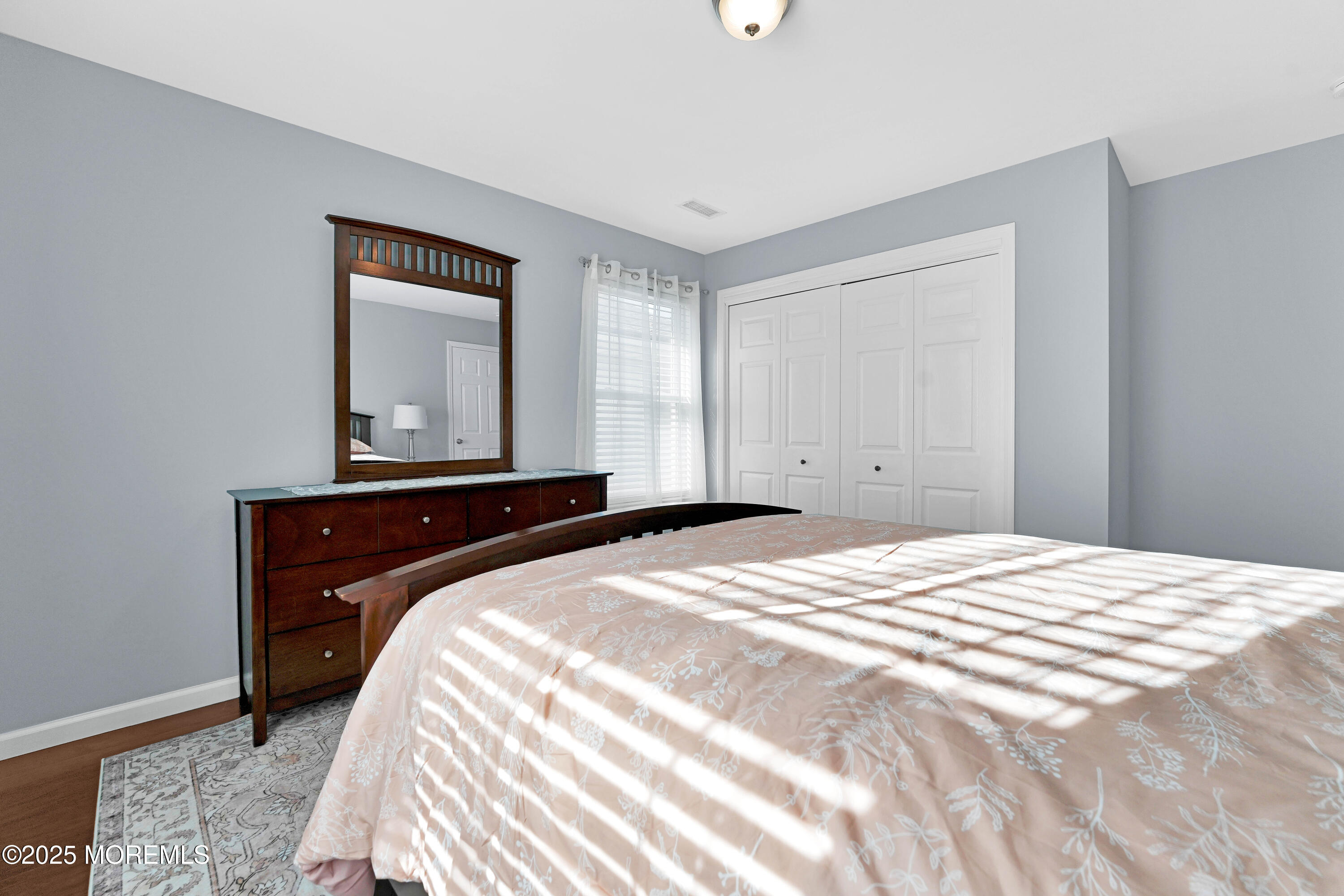 115 Harding Avenue, Unit B Seaside Heights, NJ 08751 - Photo 12 of 16 a bedroom with a bed and a mirror