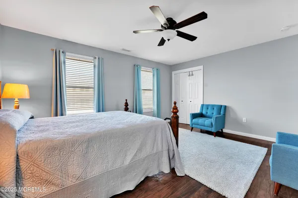 a bedroom with a bed and a mirror