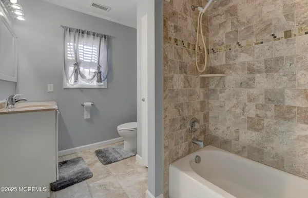 a bathroom with a bathtub sink and toilet