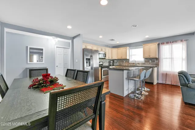 a bathroom with a granite countertop sink toilet a mirror and shower