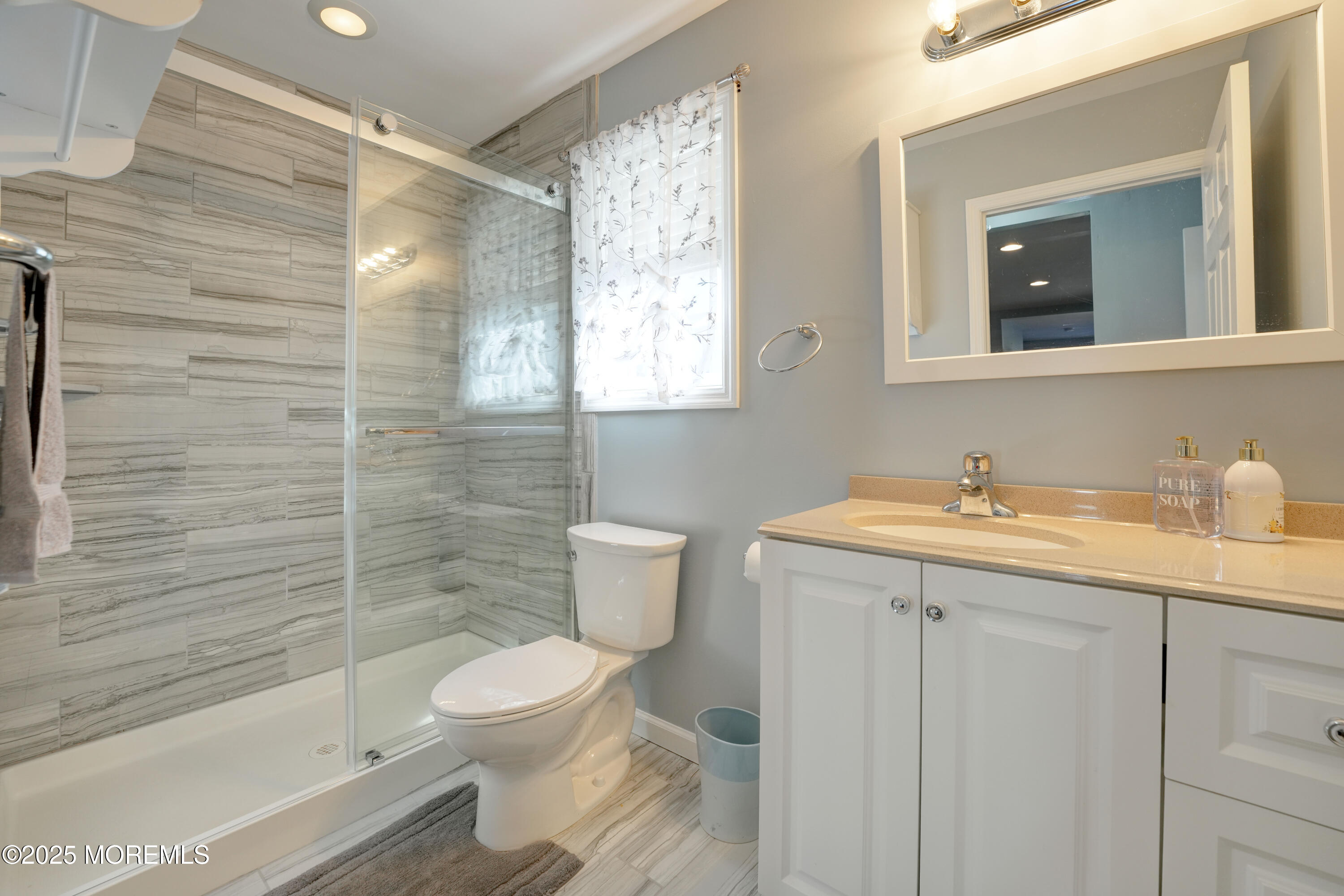 115 Harding Avenue, Unit B Seaside Heights, NJ 08751 - Photo 9 of 16 a bathroom with a granite countertop sink toilet a mirror and shower