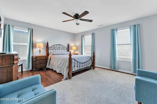 a bed room with a bed a chandelier and a window