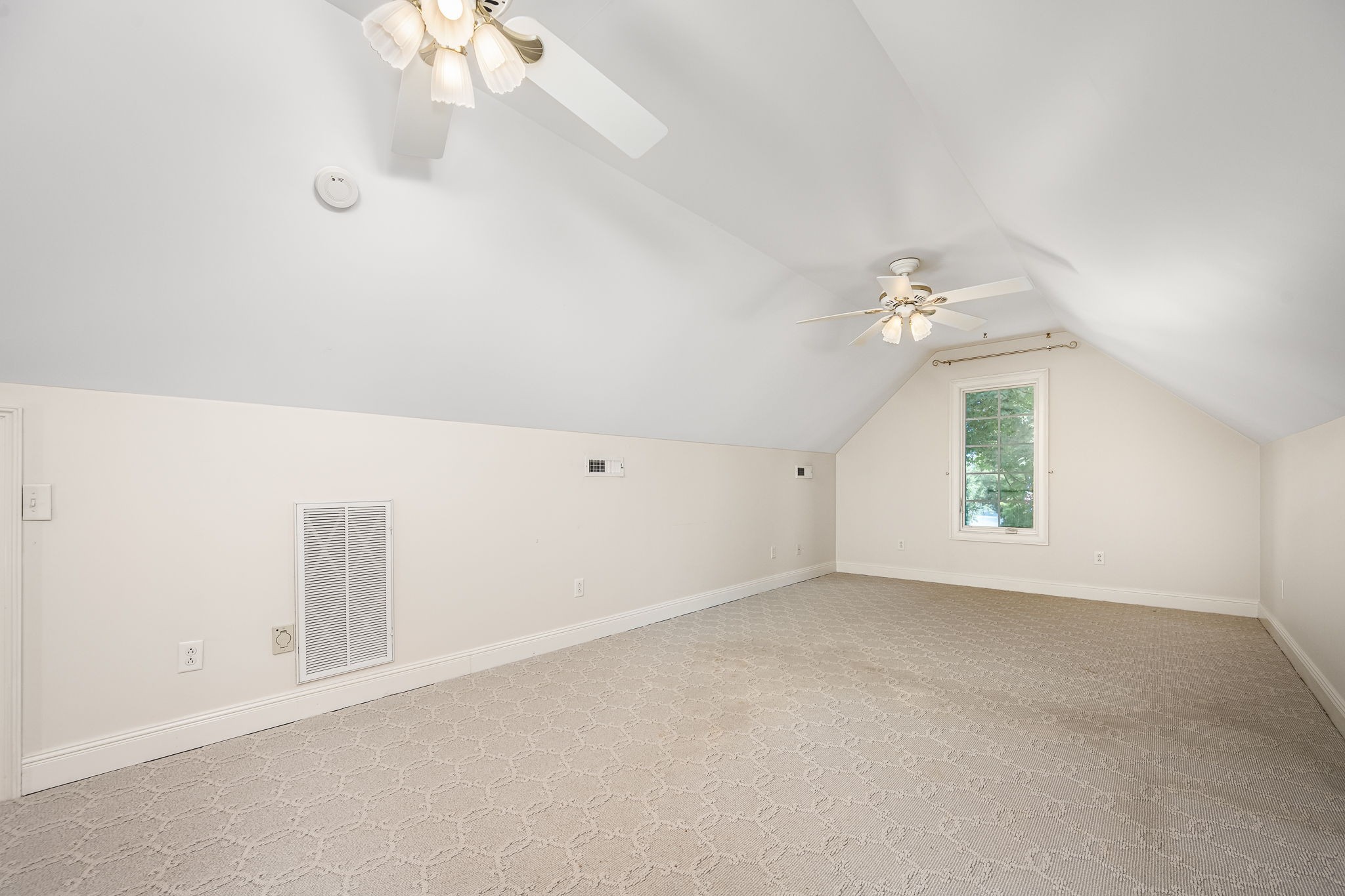 255 Parks Drive Normandy, TN 37360 - Photo 22 of 82 an empty room with a chandelier fan and windows