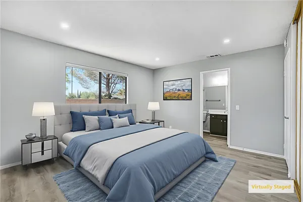 a bedroom with a bed and a night stand