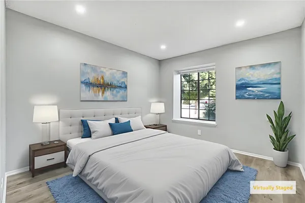 a bedroom with bed and painting on the wall