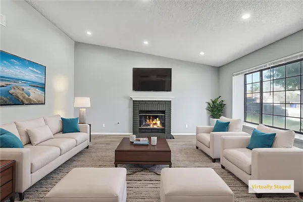 a living room with furniture and a fireplace
