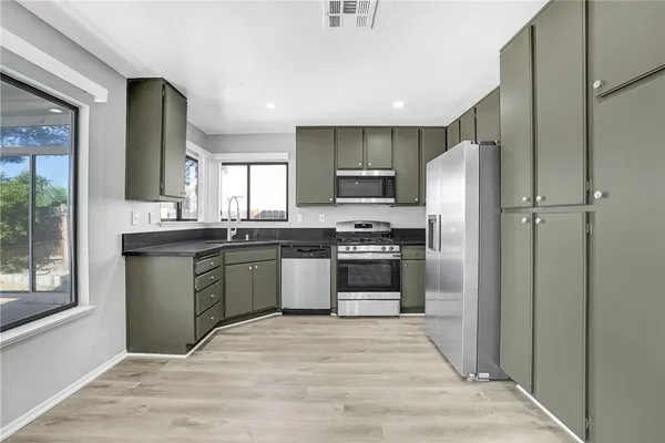 a kitchen with a refrigerator sink and stove