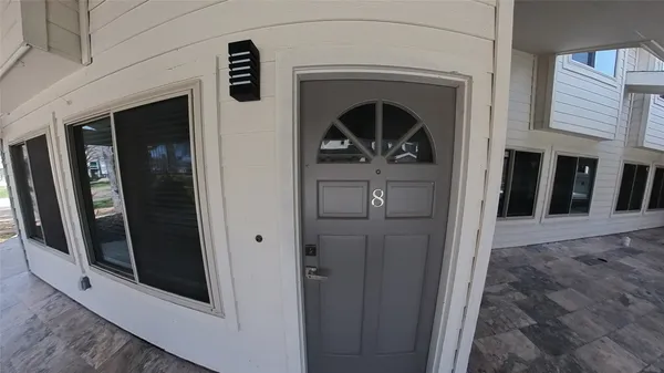 a view of a porch with a floor to ceiling window