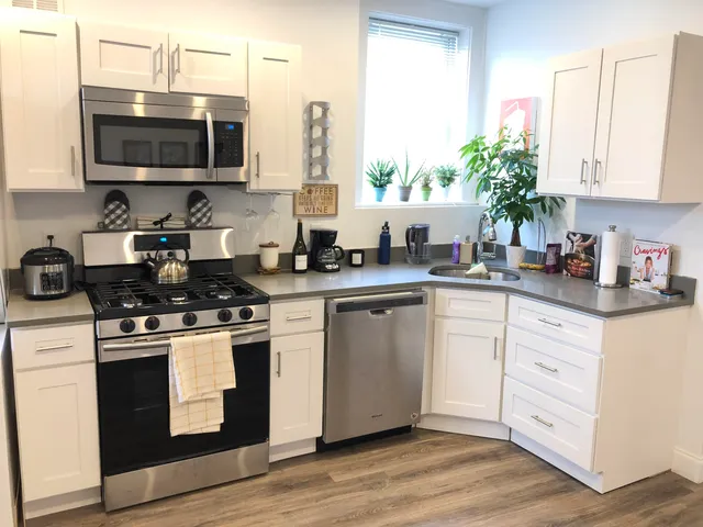 a kitchen with a sink stove and microwave