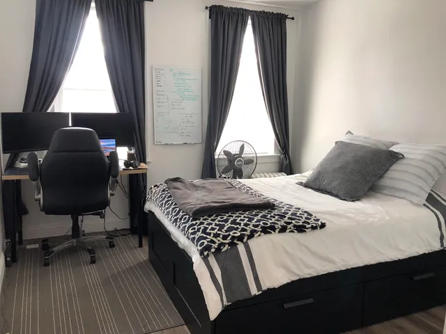 a bedroom with a bed and a window