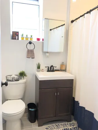 a bathroom with a sink mirror vanity and toilet