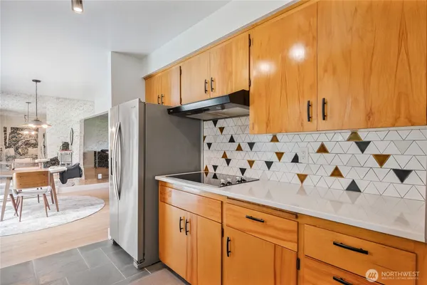 a kitchen with stainless steel appliances granite countertop a refrigerator and a sink