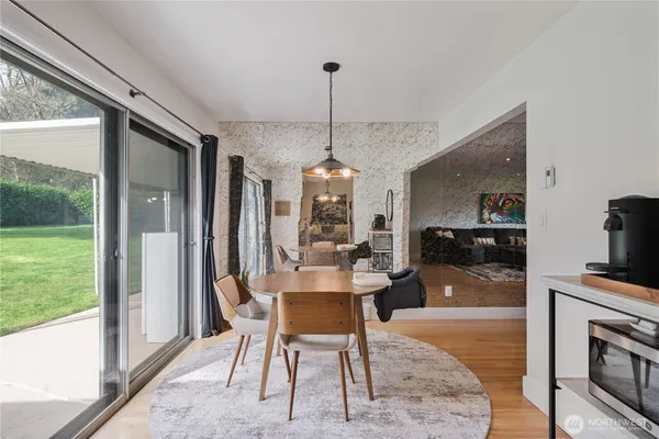 a dining room with furniture a chandelier and fireplace