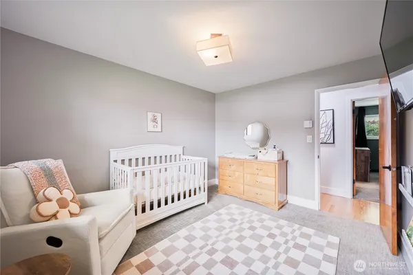 a bedroom with furniture and wooden floor
