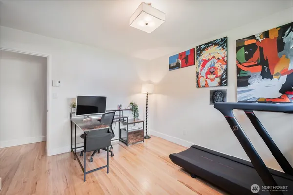 a view of a workspace with furniture and wooden floor