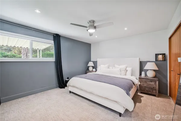 a bedroom with a large bed and a chandelier