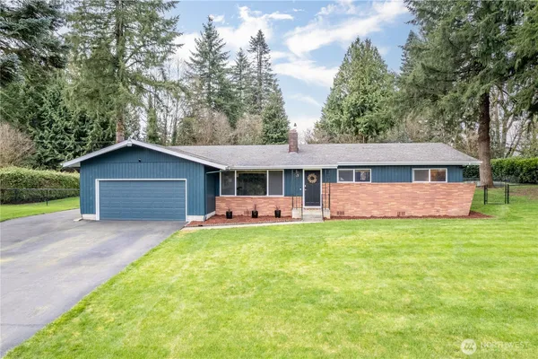 a front view of house with yard and green space