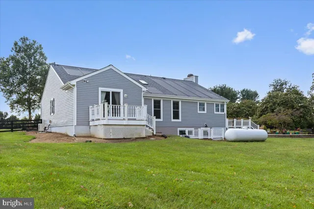 a front view of a house with a garden and yard