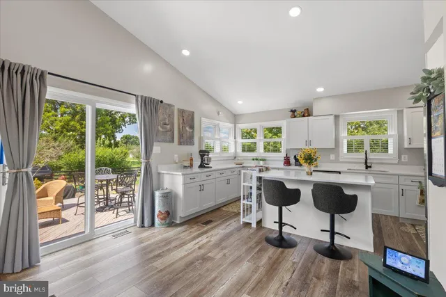 a kitchen with sink cabinets and dining table