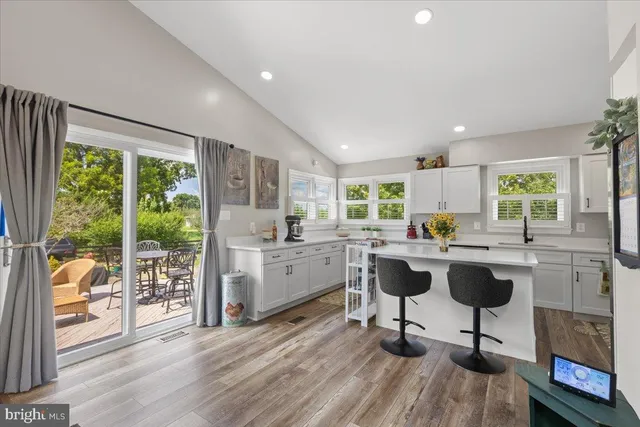 a kitchen with sink cabinets and dining table