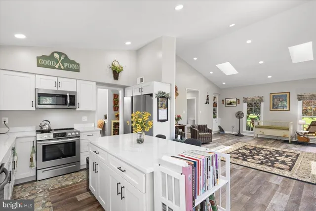 a kitchen with stainless steel appliances granite countertop a stove top oven a sink a counter top space and cabinets