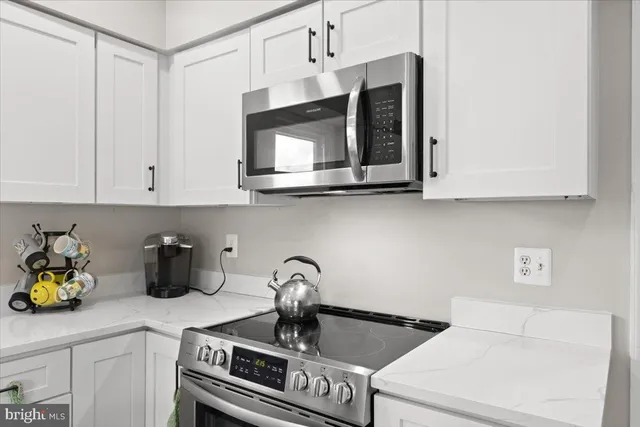a kitchen with a sink a stove and cabinets