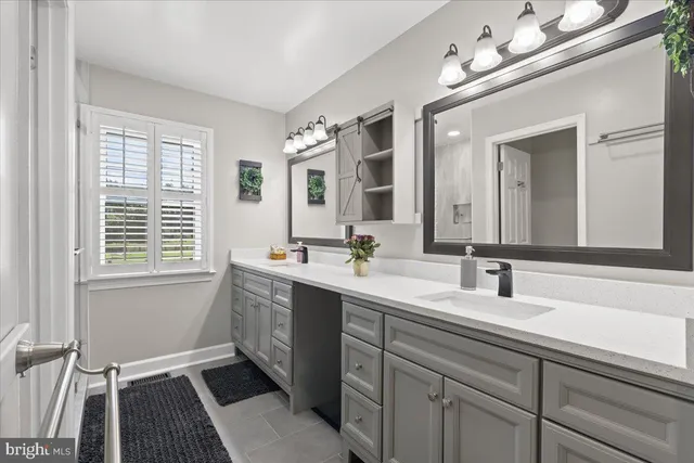 a bathroom with a sink double vanity and a mirror