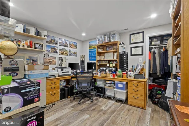 a room with furniture a bookshelf and a window