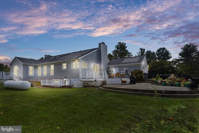 a house view with a sitting space and garden