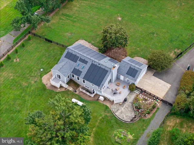 an aerial view of a house with garden space and street view