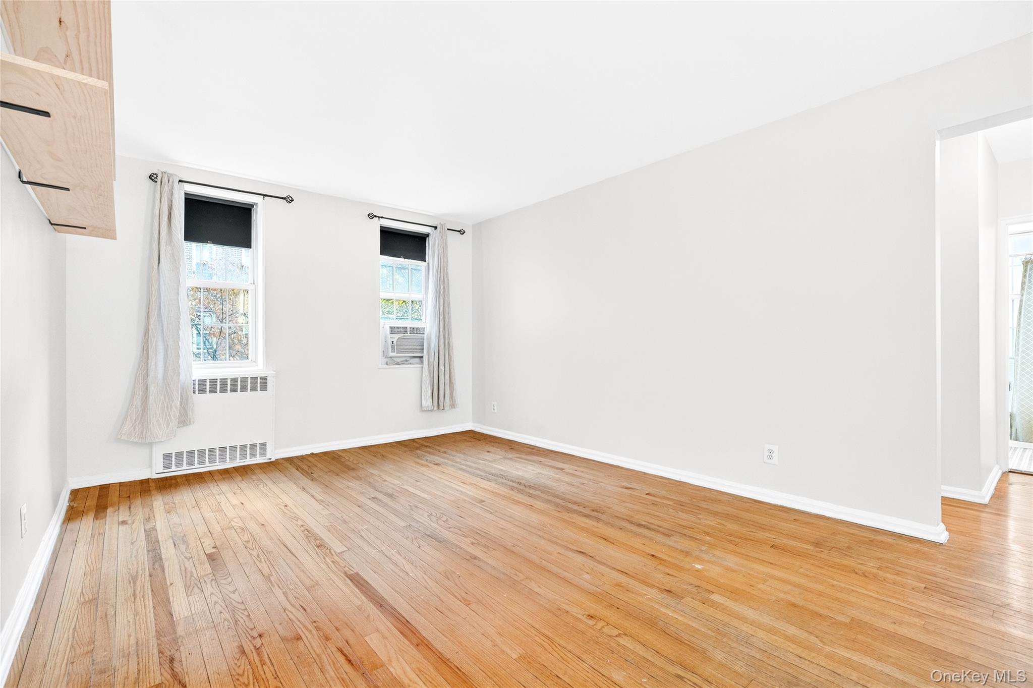 770 Bronx River Road, Unit A36 Bronxville, NY 10708 - Photo 7 of 22 an empty room with wooden floor and windows