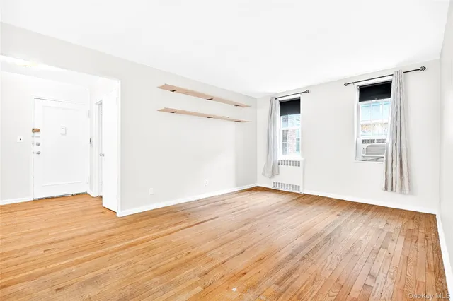 a view of hallway with wooden floor