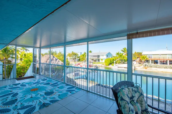 a kitchen with a dining table chairs sink and cabinets