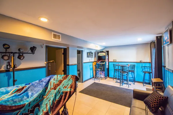 a bedroom with furniture and a large window