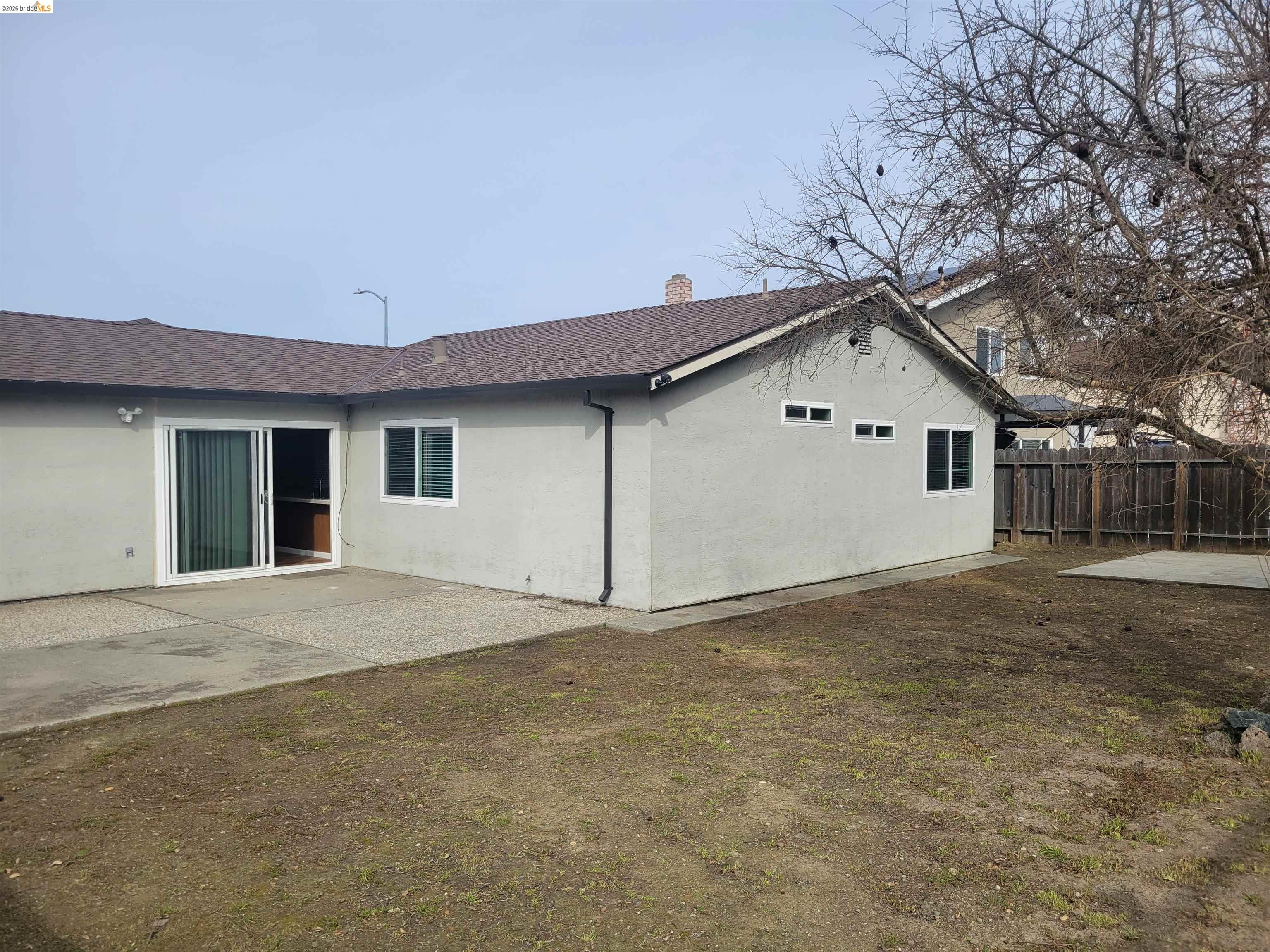 906 Coral Drive Rodeo, CA 94572 - Photo 18 of 21 a view of a house with a yard and garage