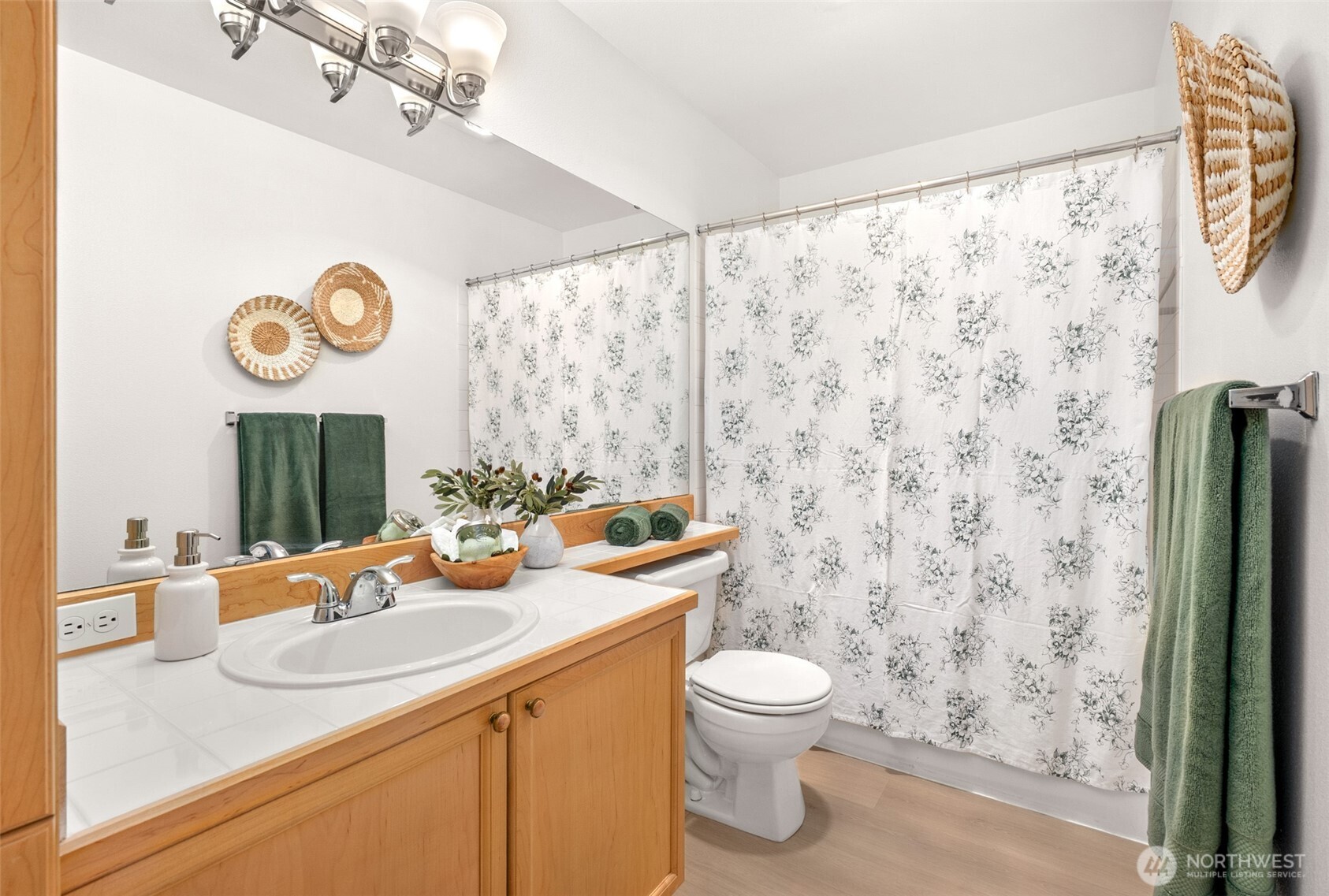 17107 123rd Place Northeast, Unit V302 Bothell, WA 98011 - Photo 13 of 20 a bathroom with a sink a toilet and a shower curtain