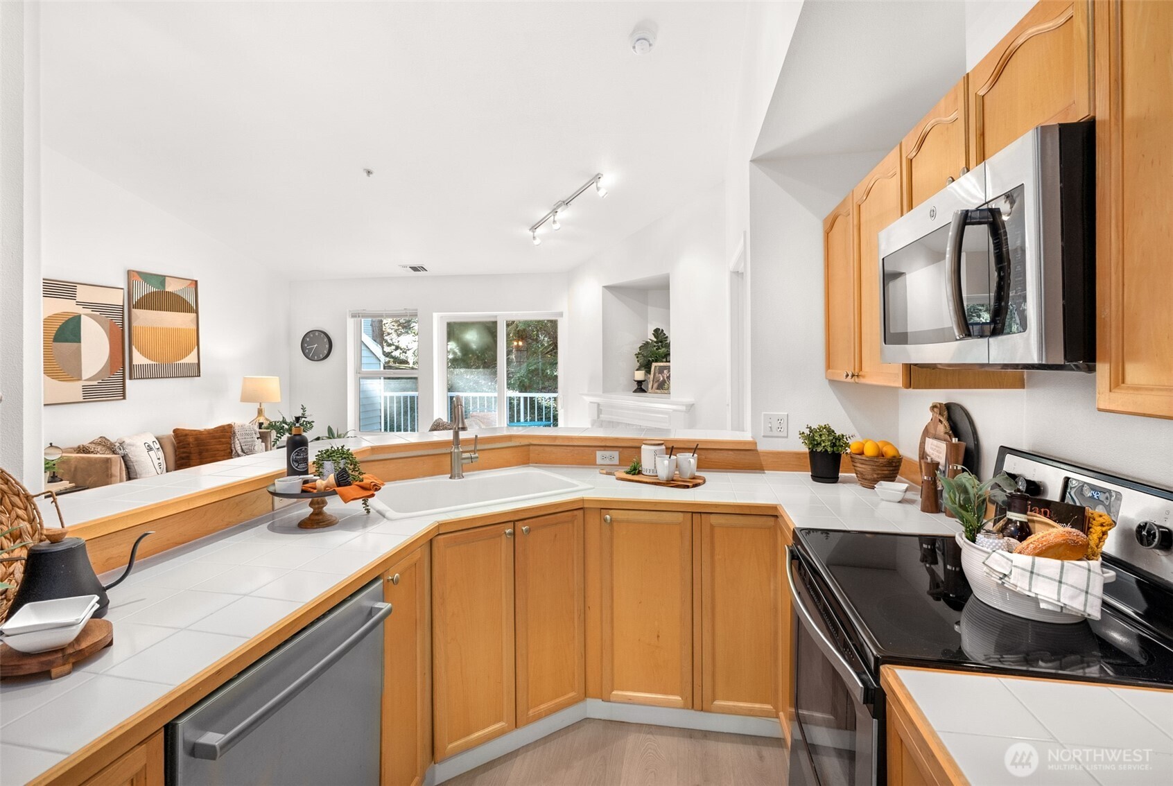 17107 123rd Place Northeast, Unit V302 Bothell, WA 98011 - Photo 8 of 20 a kitchen with a sink stove and microwave