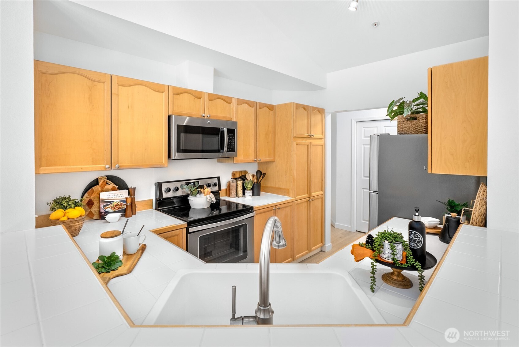 17107 123rd Place Northeast, Unit V302 Bothell, WA 98011 - Photo 9 of 20 a kitchen that has a sink and a stove top oven