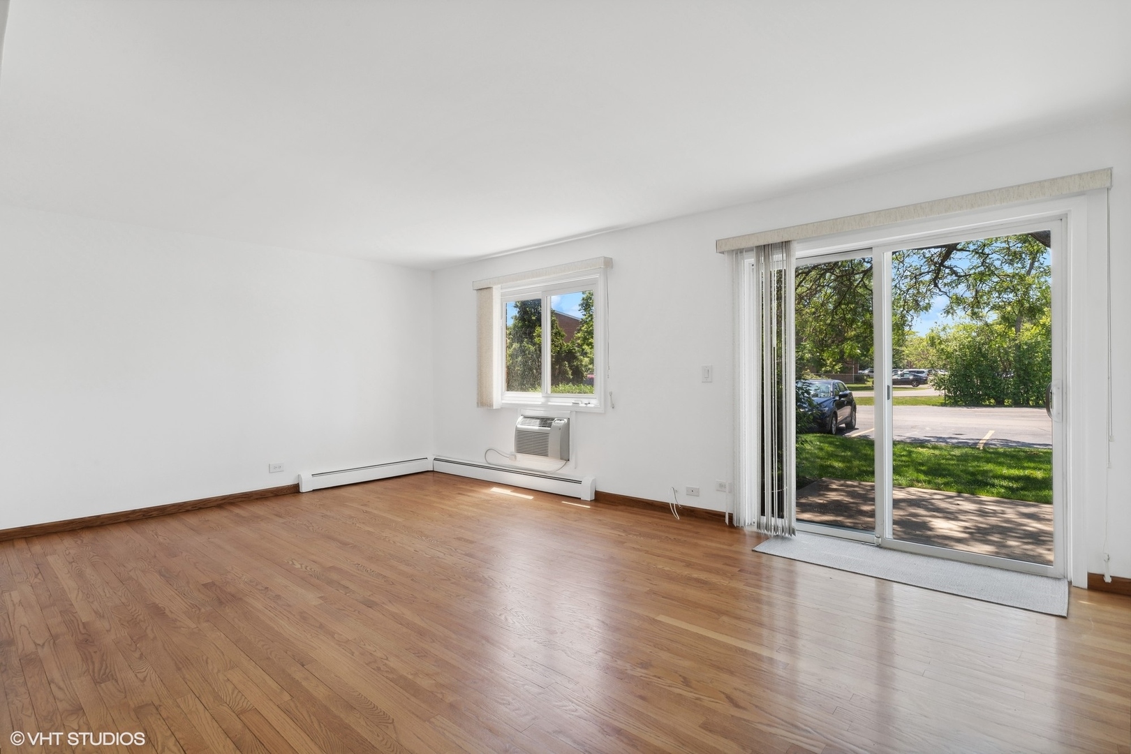10357 Dearlove Road, Unit 1I Glenview, IL 60025 - Photo 2 of 16 a view of an empty room with wooden floor and a window