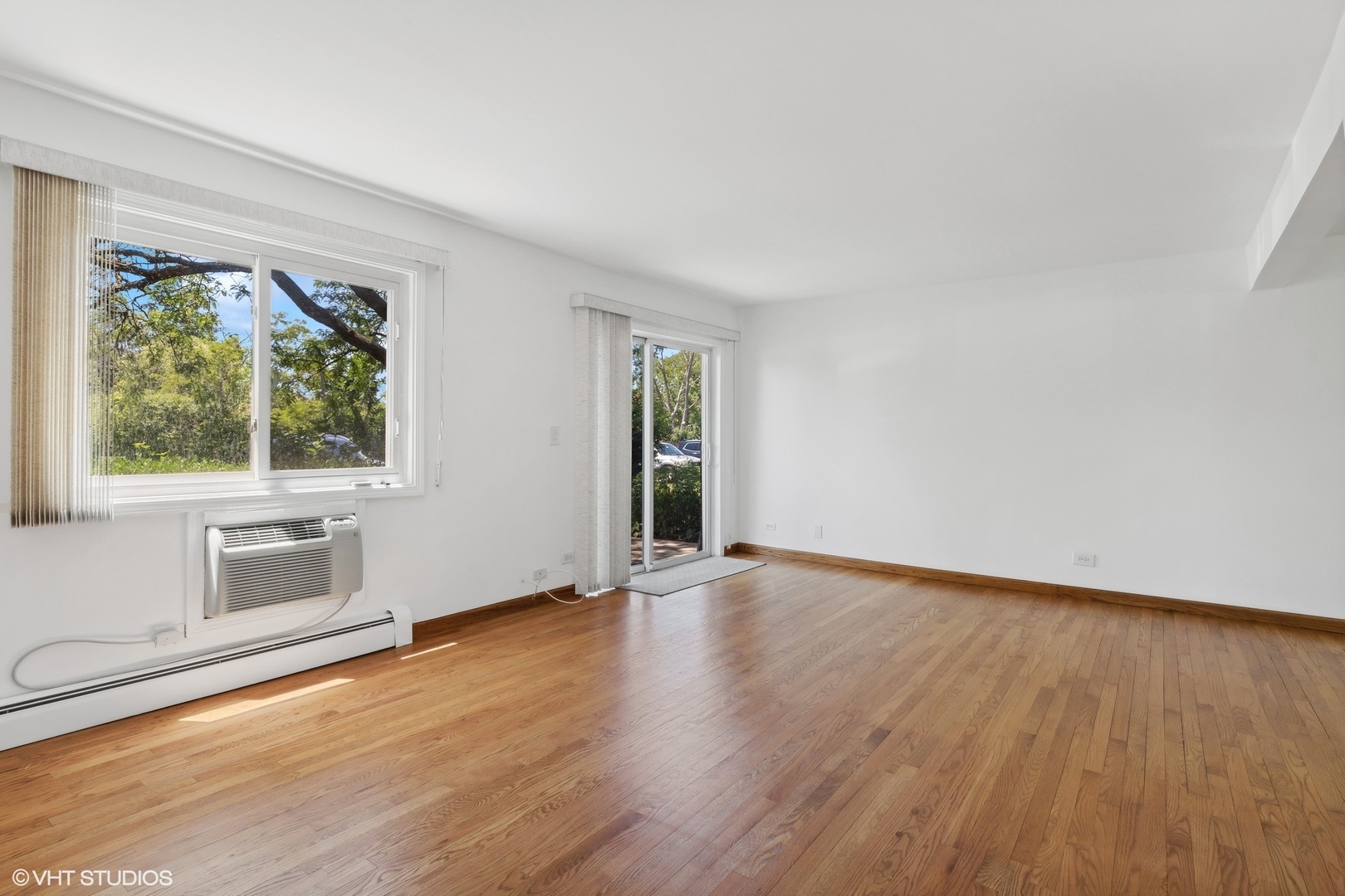 10357 Dearlove Road, Unit 1I Glenview, IL 60025 - Photo 3 of 16 a view of an empty room with wooden floor and a window