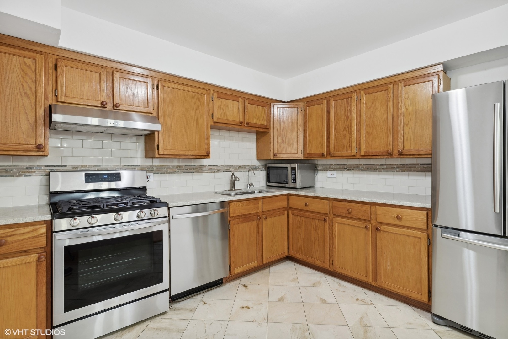 10357 Dearlove Road, Unit 1I Glenview, IL 60025 - Photo 4 of 16 a kitchen with granite countertop cabinets stainless steel appliances and a sink