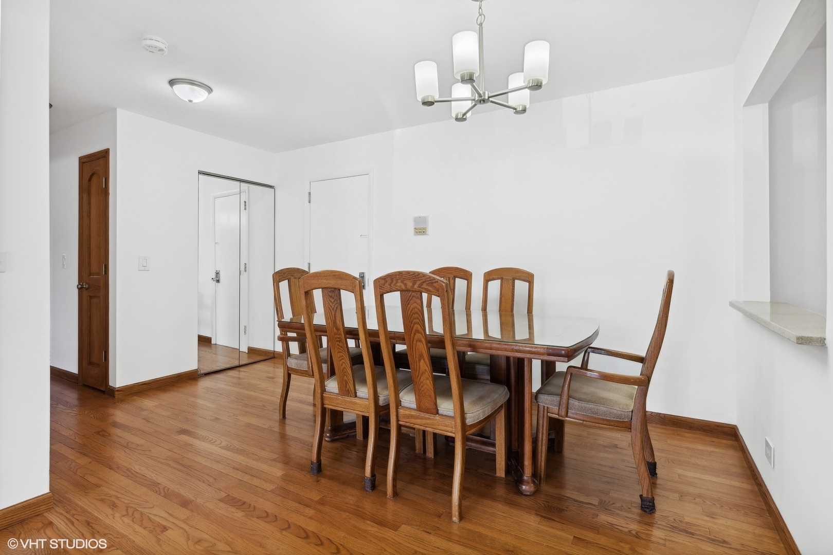 10357 Dearlove Road, Unit 1I Glenview, IL 60025 - Photo 5 of 16 a view of a dining room with furniture and wooden floor