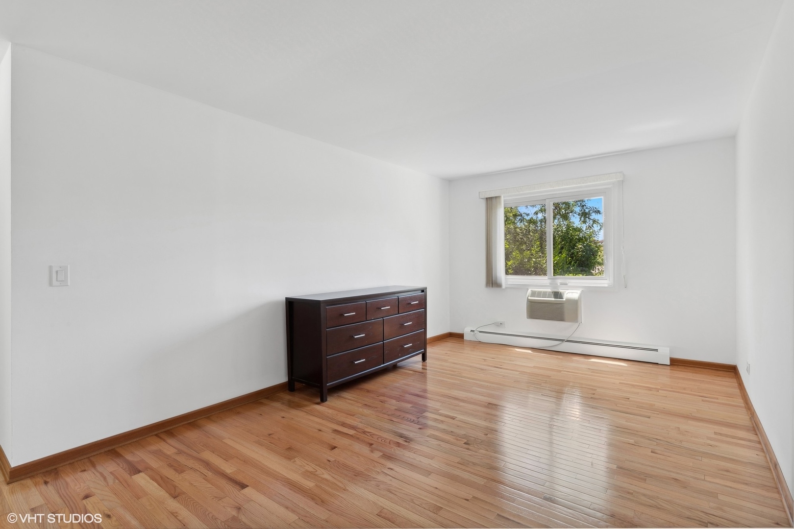 10357 Dearlove Road, Unit 1I Glenview, IL 60025 - Photo 8 of 16 an empty room with wooden floor and windows